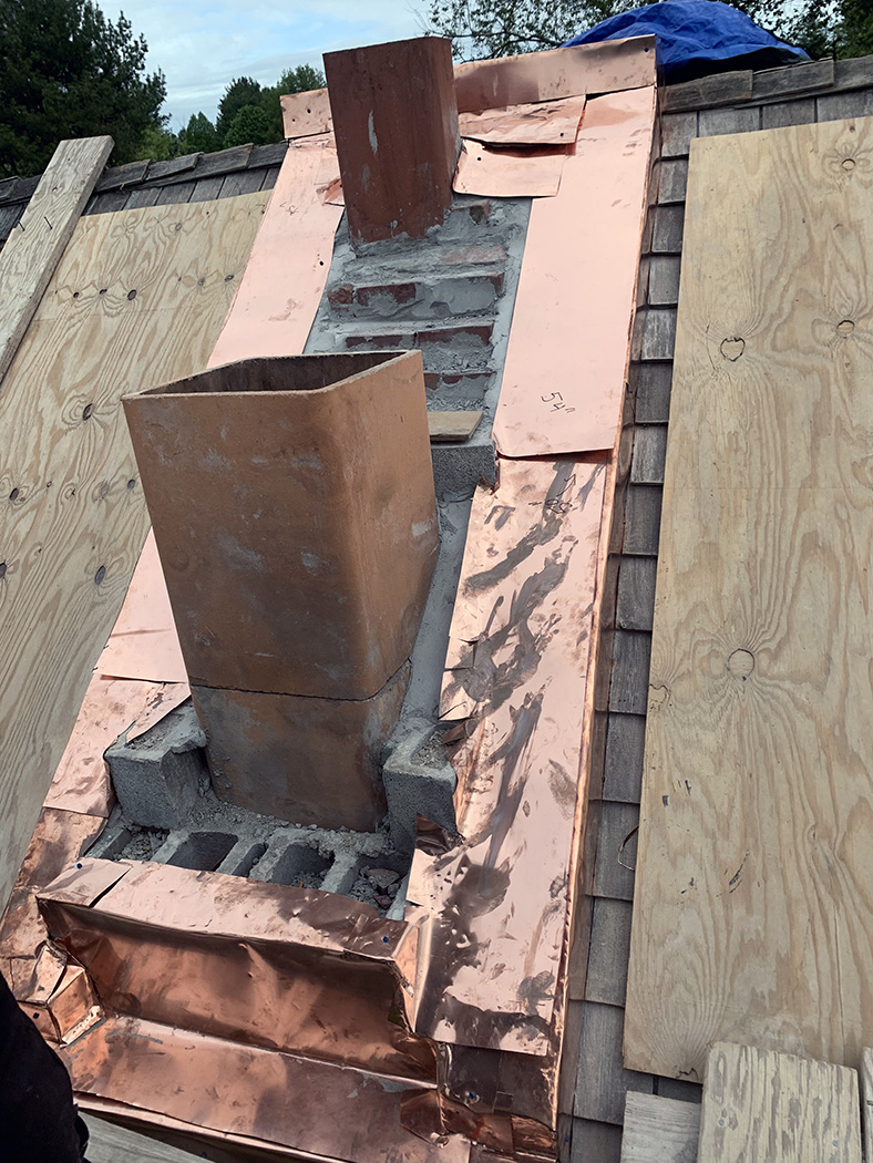 stone house chimney copper pan